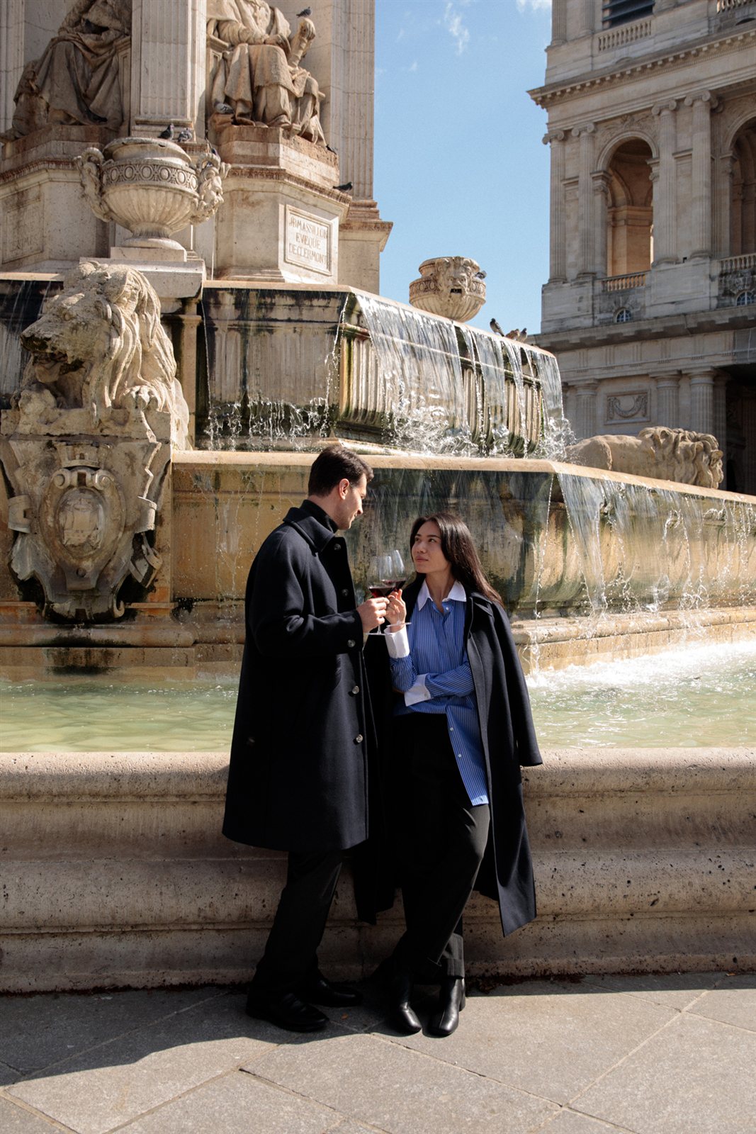 Glasses of wine enjoyed near the Saint-Sulpice Fountain in Paris.